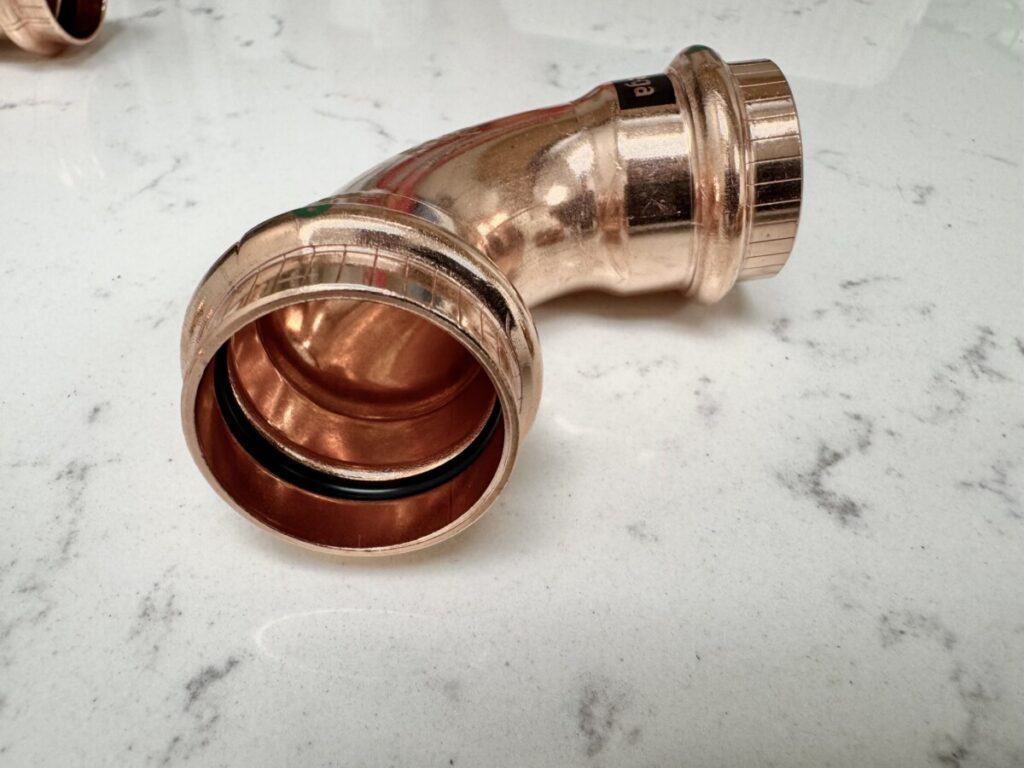 what is a propress fitting in plumbing water propress fitting elbow ring on a table