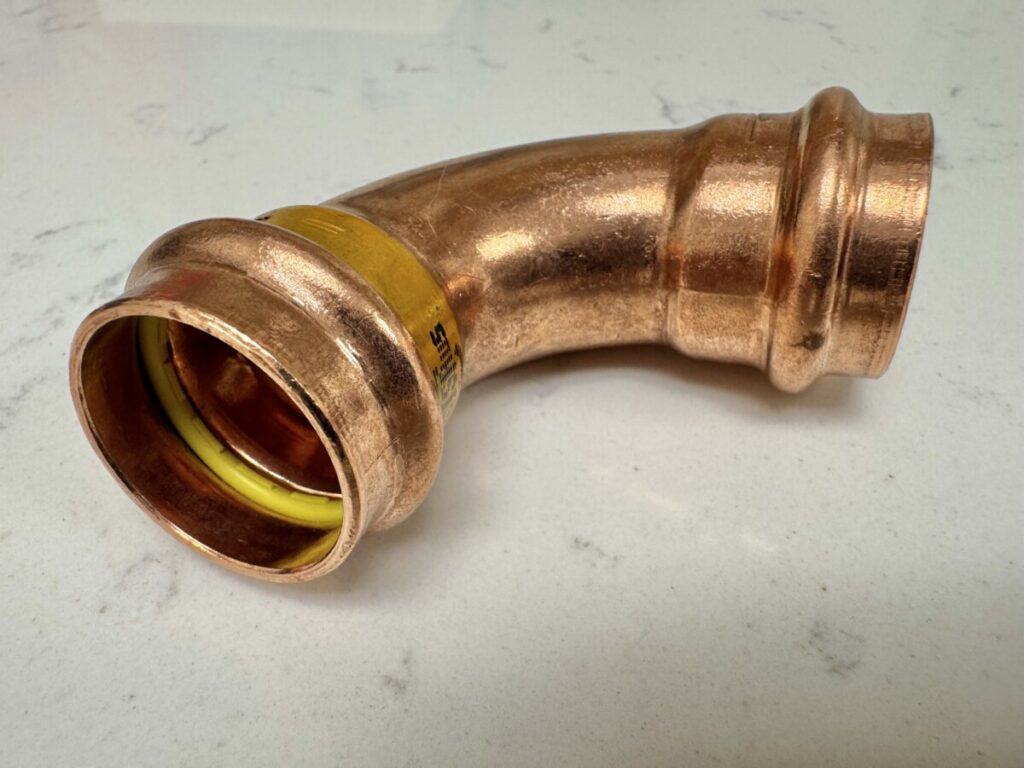 What is a ProPress fitting in plumbing gas rated copper propress elbow fitting on a table